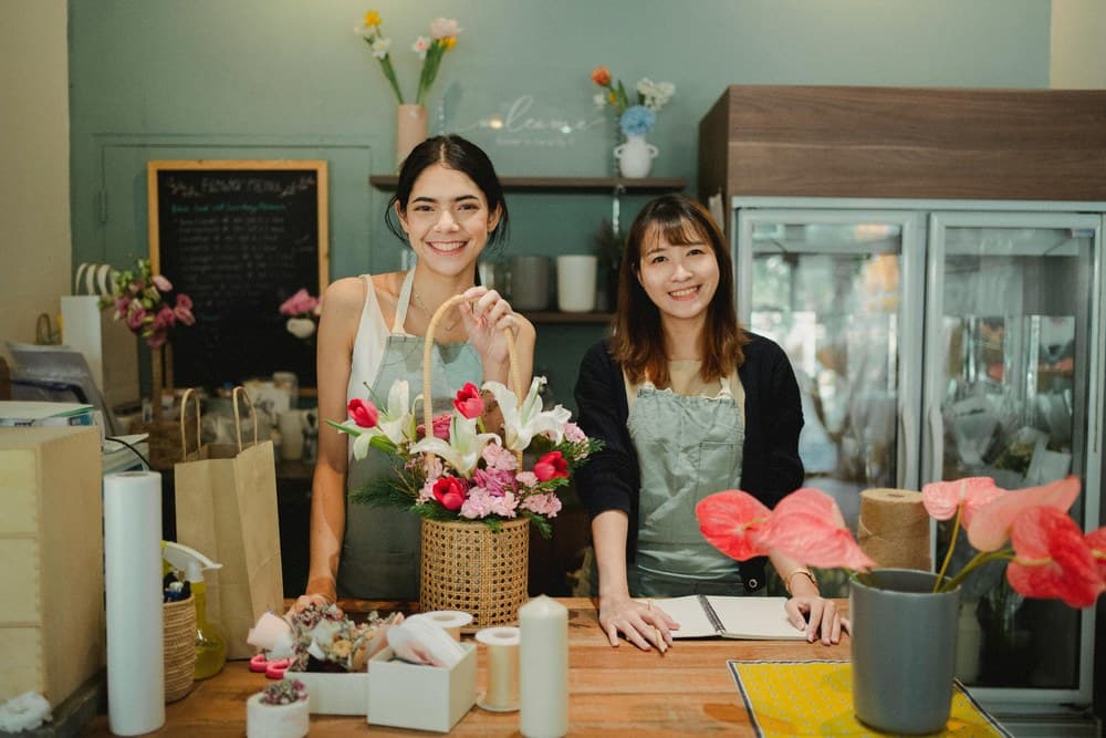 Two florists working in their flower shop