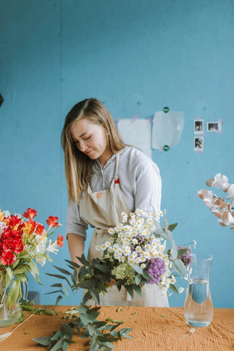 Person arranging flowers in a shop